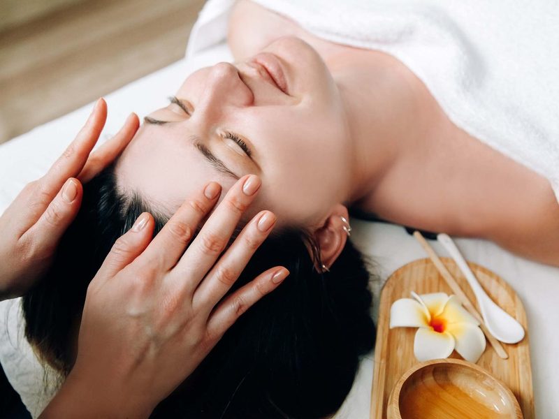 Esthetician performing a hydrating facial massage
