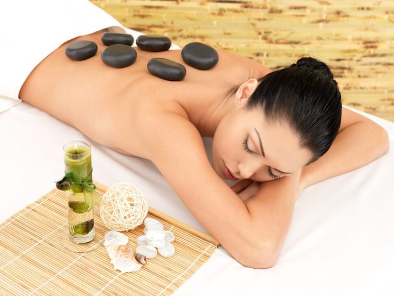 Hot stone massage with heated basalt stones placed along the back