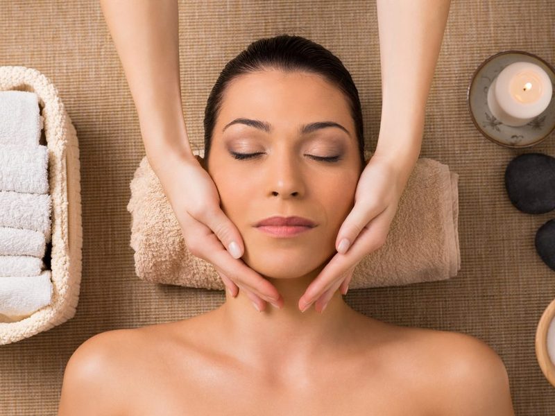 Client relaxing during a facial aesthetics treatment at Stillwater Wellness