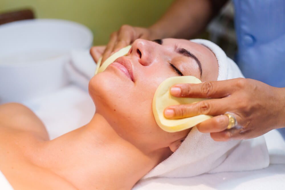 Esthetician applying a peel treatment to a client’s face at Stillwater Wellness